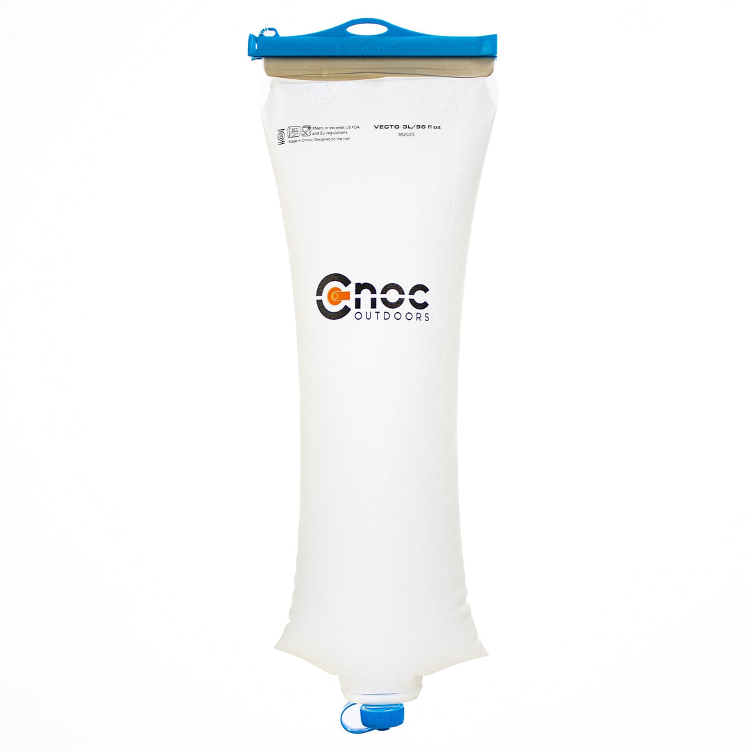 A transparent Cnoc Vecto 28mm water container with blue slider and cap