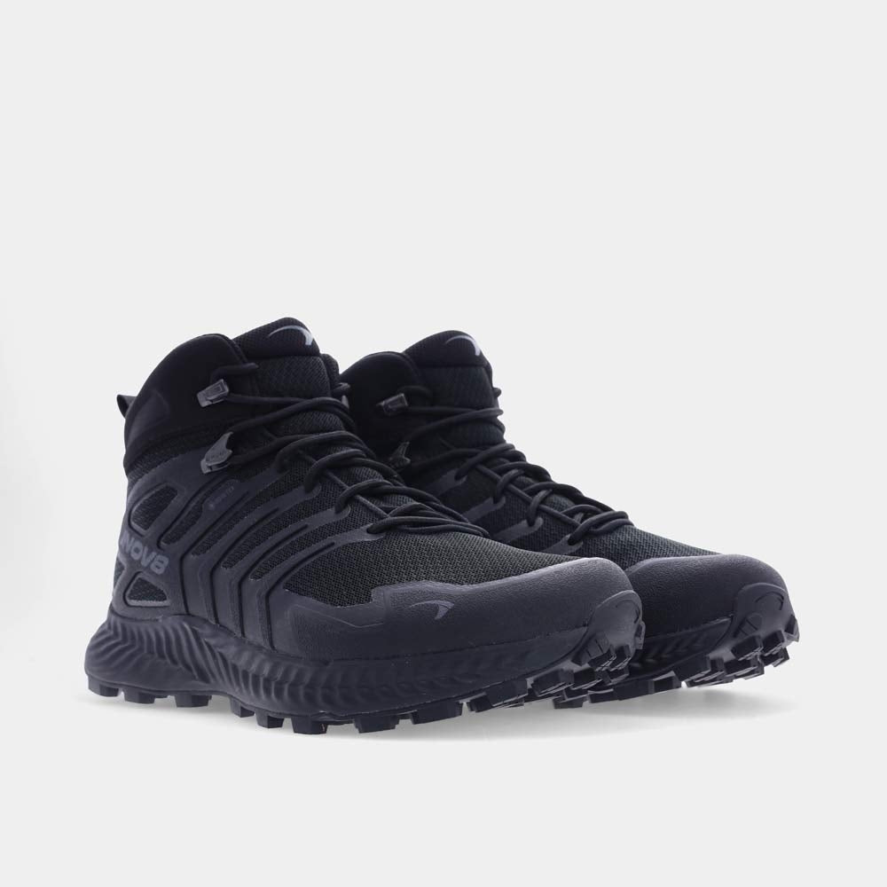 A pair of black hiking boots on a white background