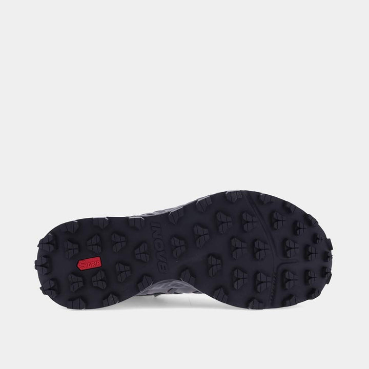 Close up of the sole of a hiking boot showing aggressive lugs on a white background