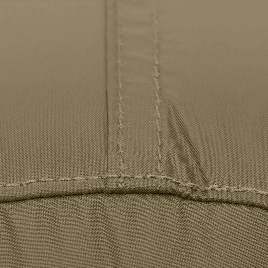 Close-up of a fabric surface in a muted taupe-beige color, showing stitched seams and a fine woven texture.