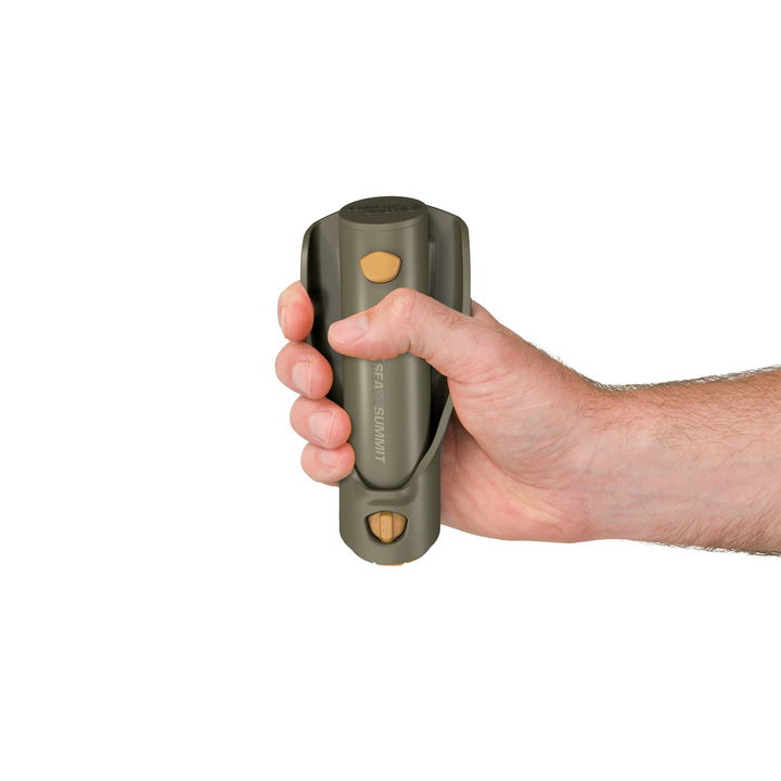 Hand holding a collapsed plastic trowel on a white background