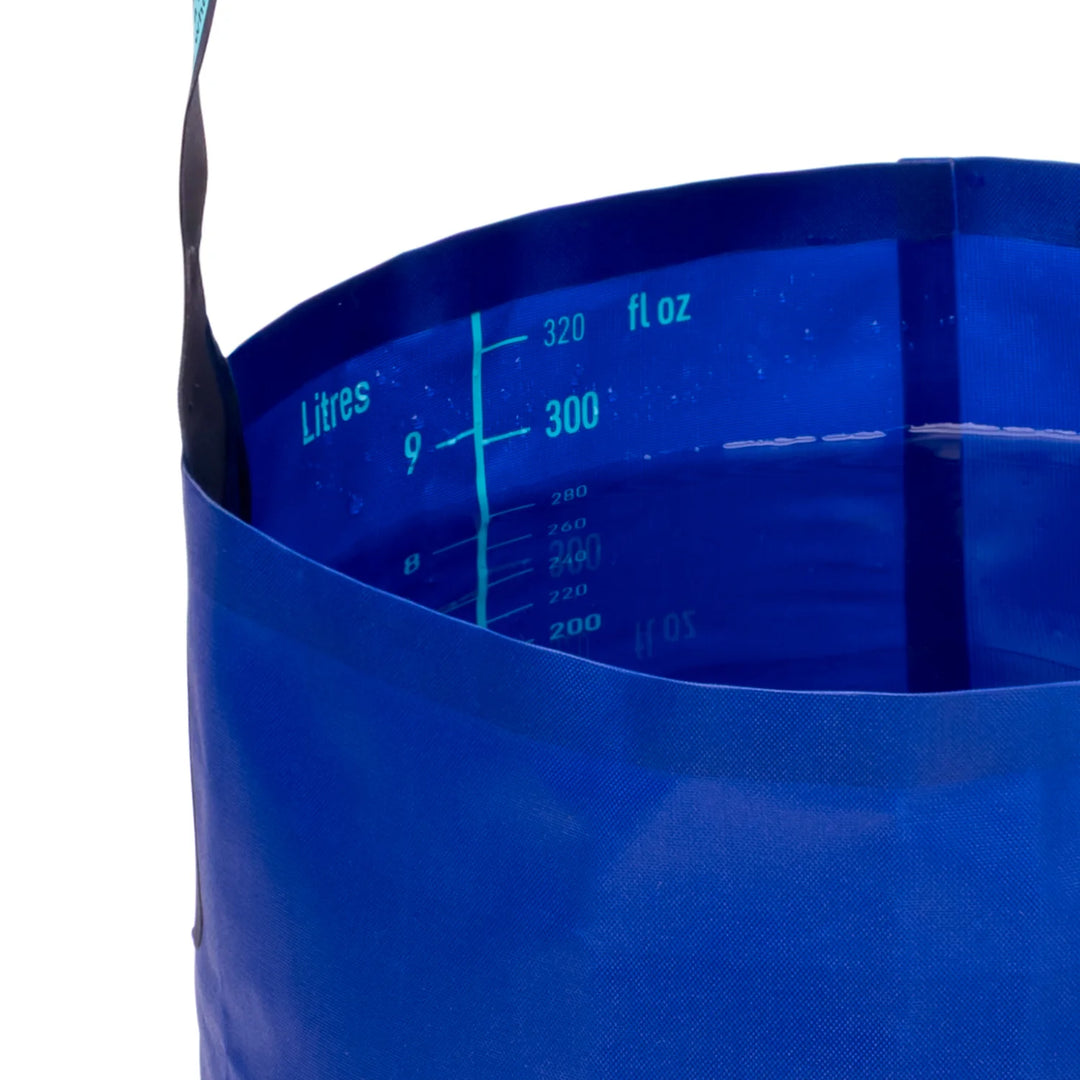 Blue collapsible bucket with measurement markings on a white background