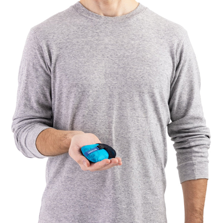 Person holding a blue and black stuff sack that fits in one hand