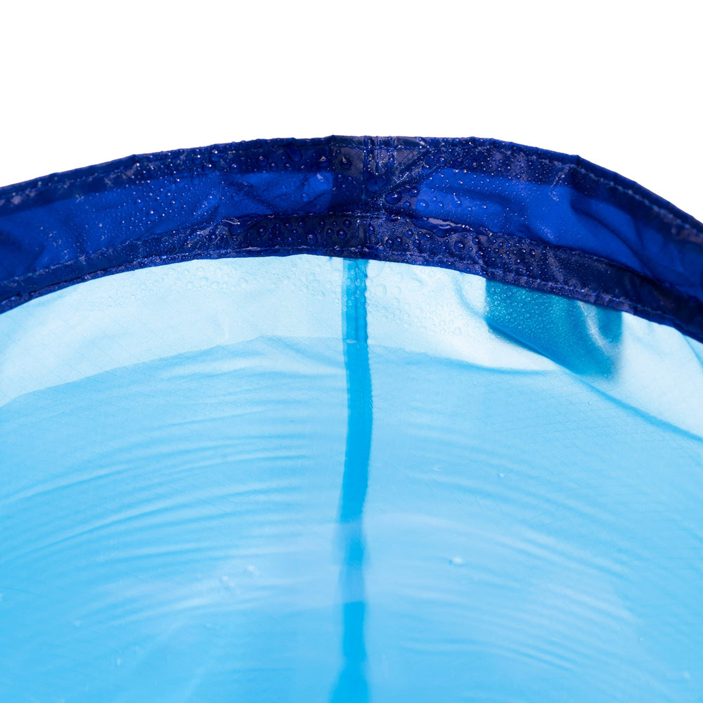 Close up of the inside rim of a nylon collapsible bucket, adorned with water droplets