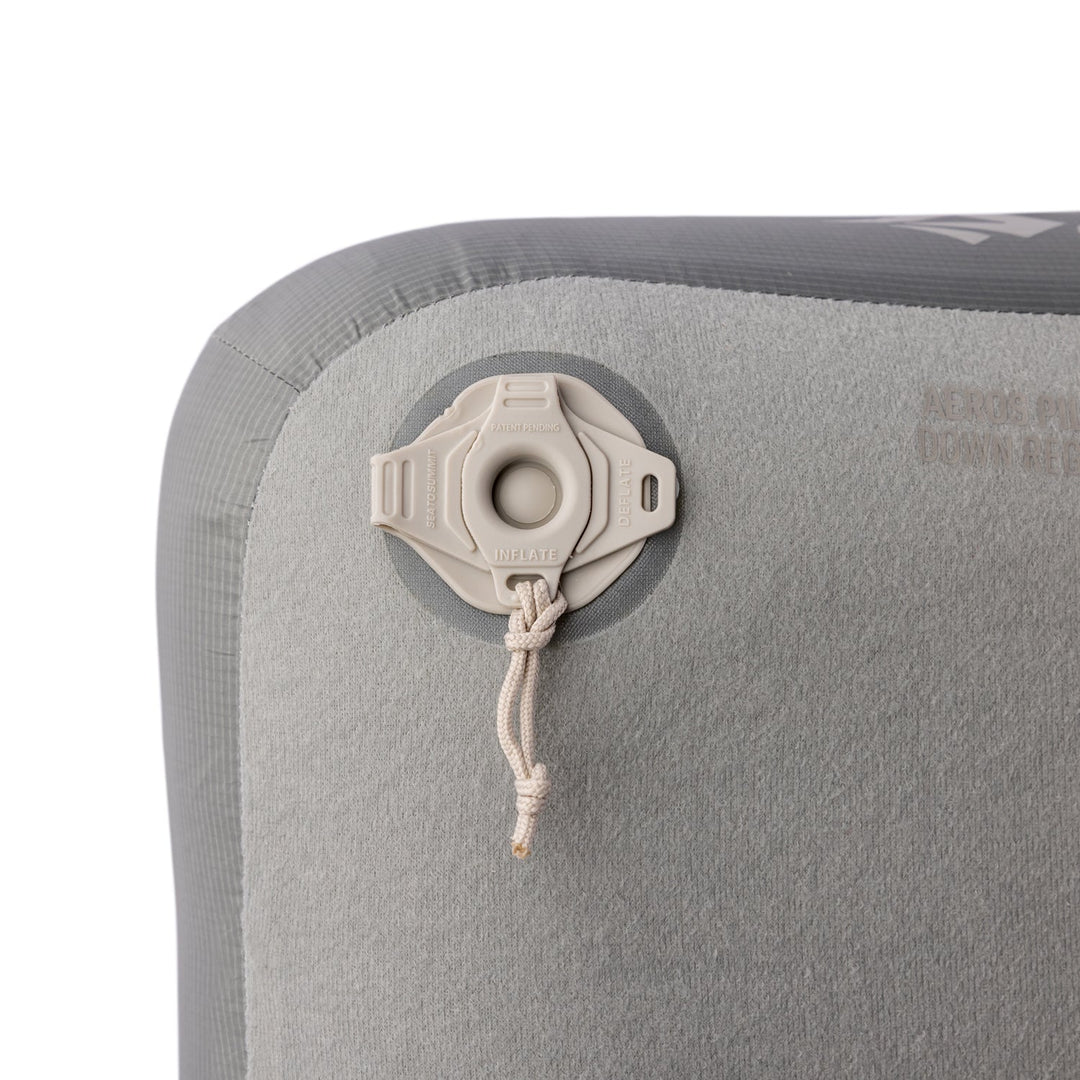 Close up of the valve on a grey inflatable pillow