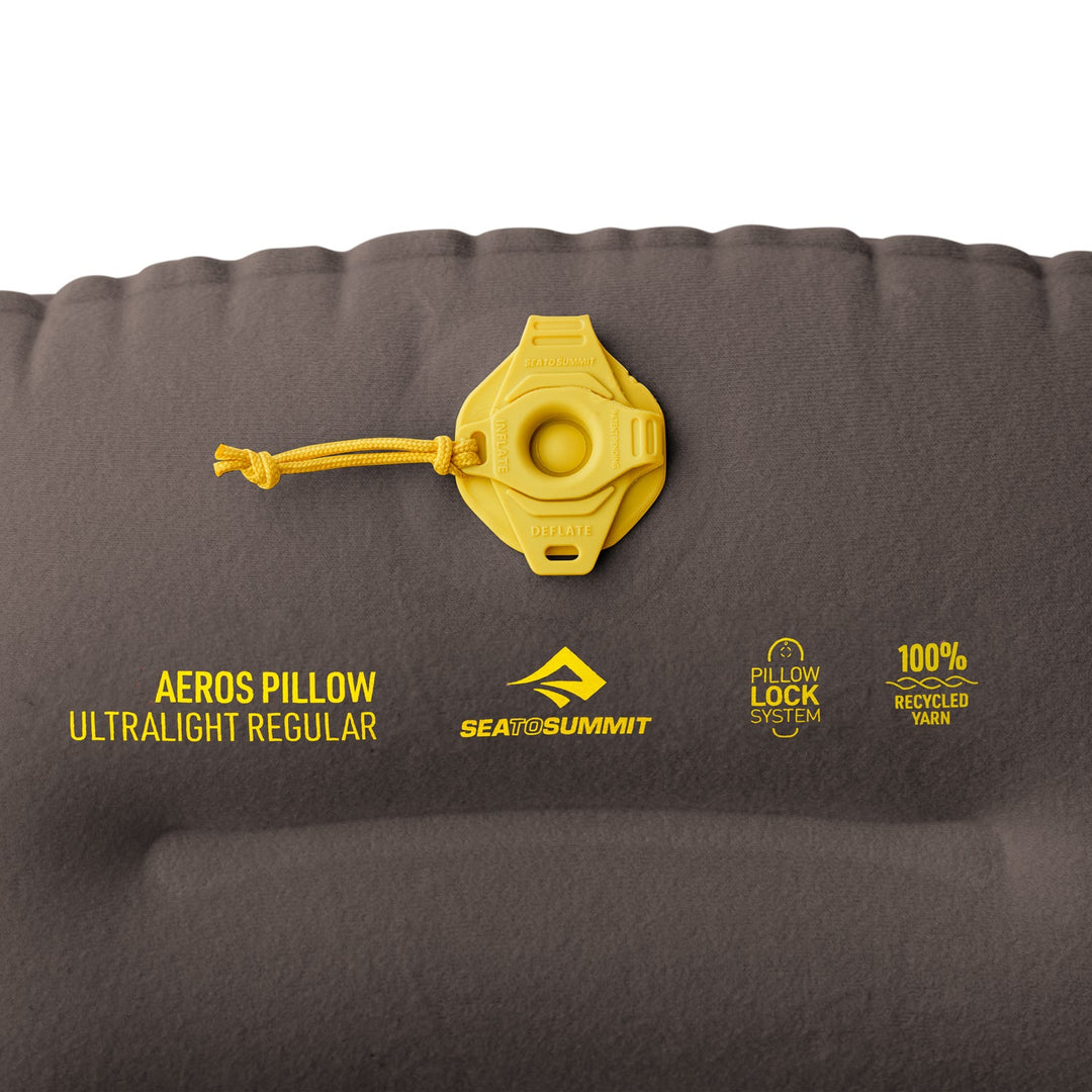 Close up of a yellow valve on a dar gray inflatable pillow