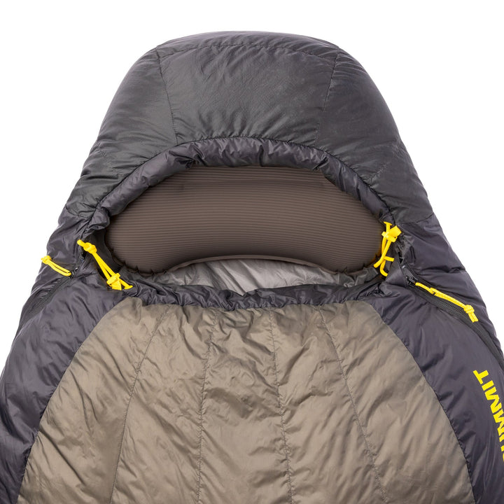 Close-up of a black sleeping bag with a inflatable pillow tucked inside the hood