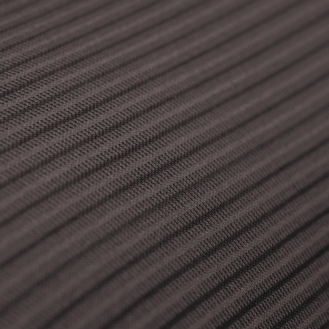 Close up of the surface of a dark gray ribbed textile