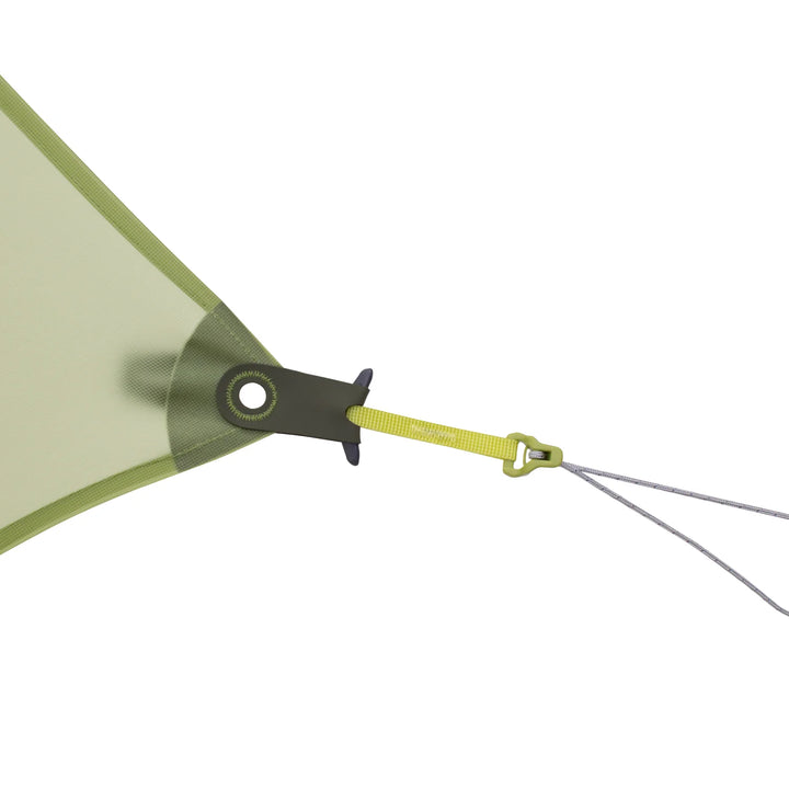 Close-up of a green tent fly with a metal grommet and yellow strap on a white background