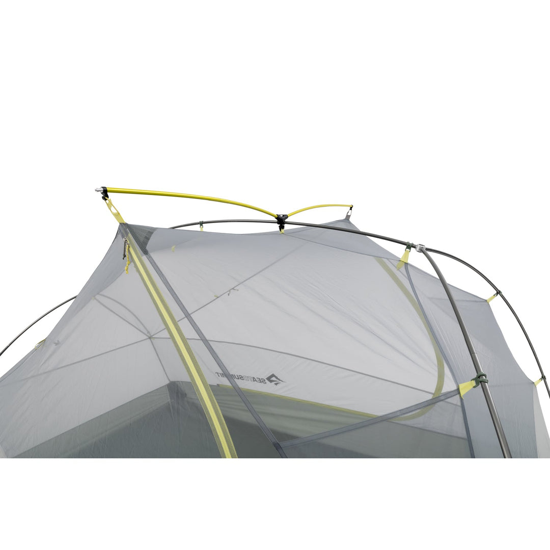 Close up of grey mesh tent inner with light green poles.