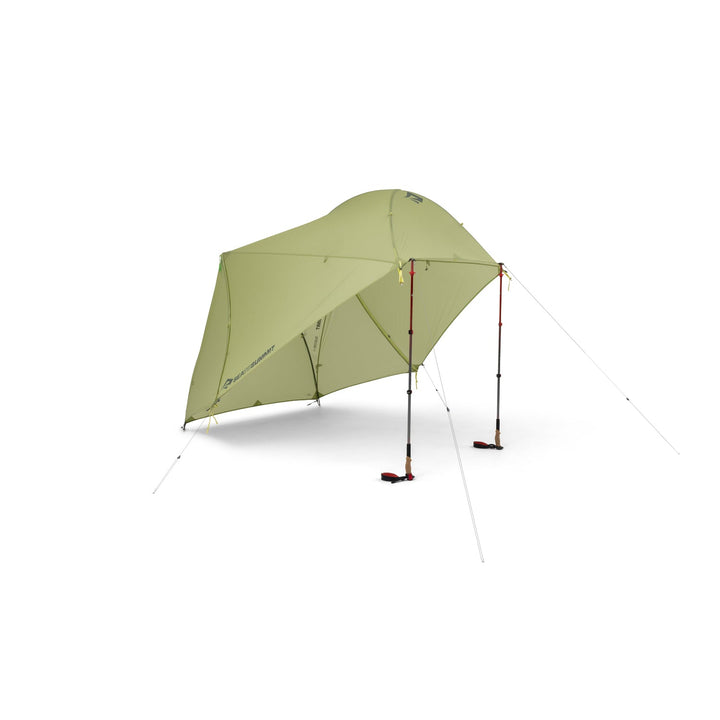 Light green tent elevated by two hiking poles on a white background.