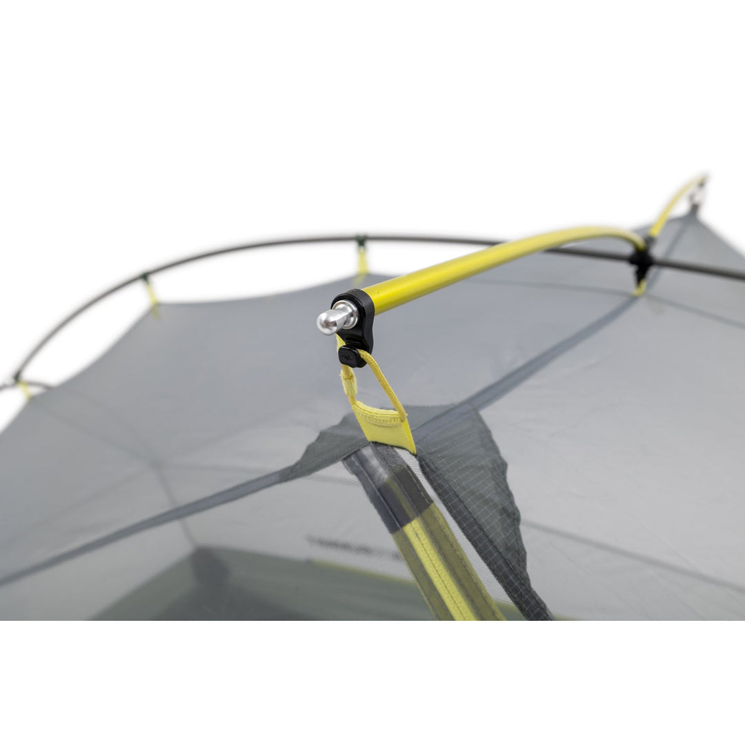 Close up grey mesh inner tent with yellow poles on a white background.