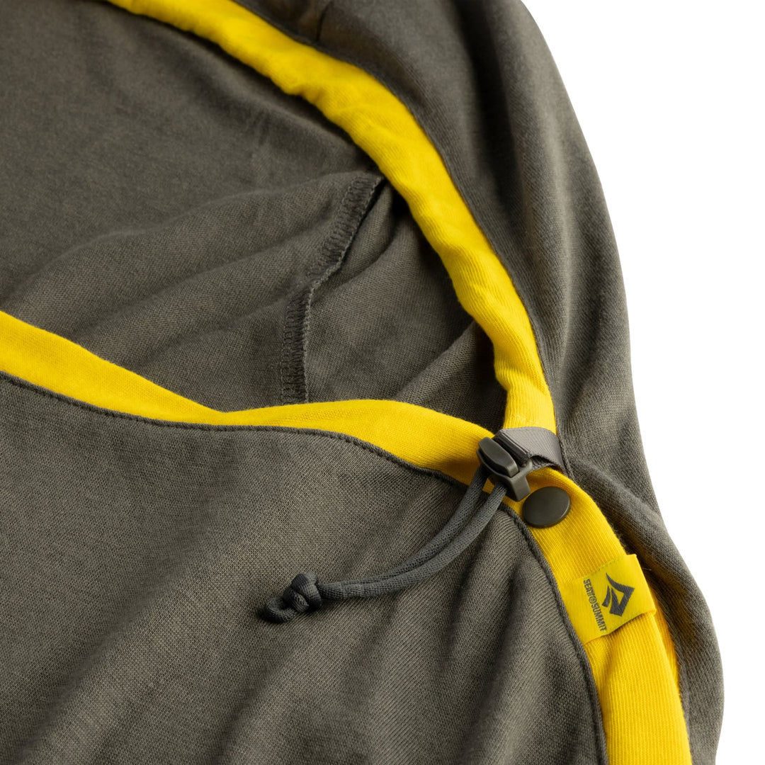 Grey sleeping bag liner with yellow trim on a white background