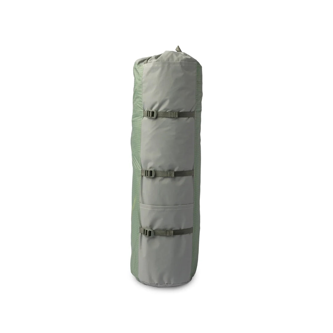Light green packed up camping tent on a white background 