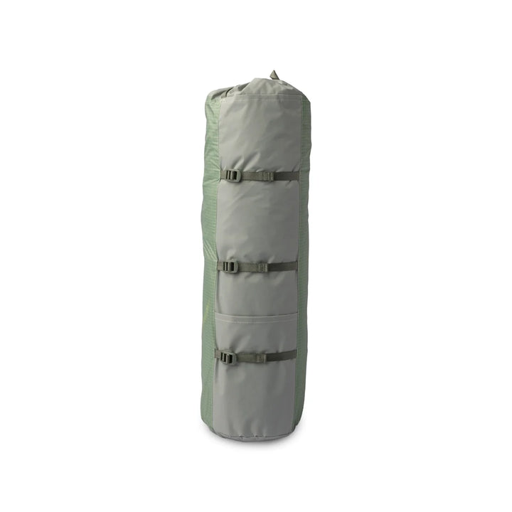 Light green packed up camping tent on a white background 