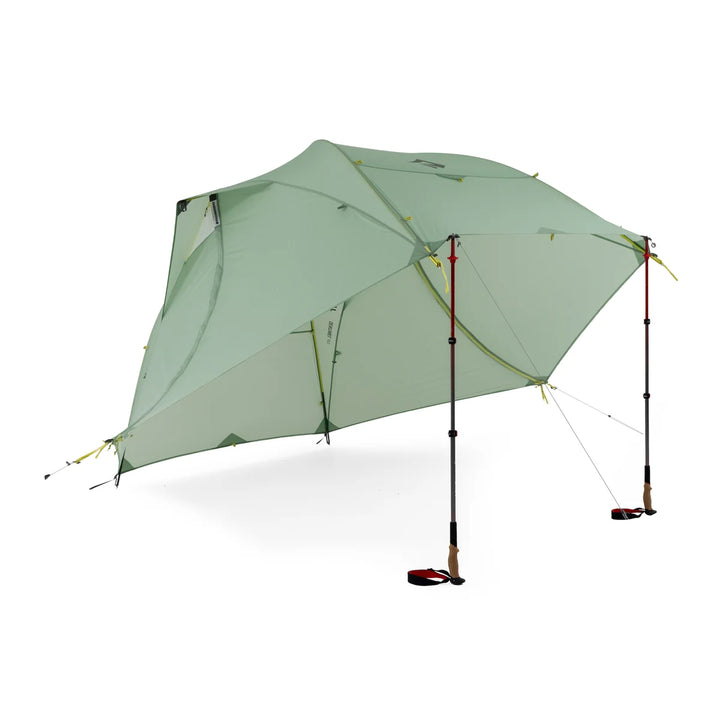 Light green camping tent fly set up without interior with poles on a white background