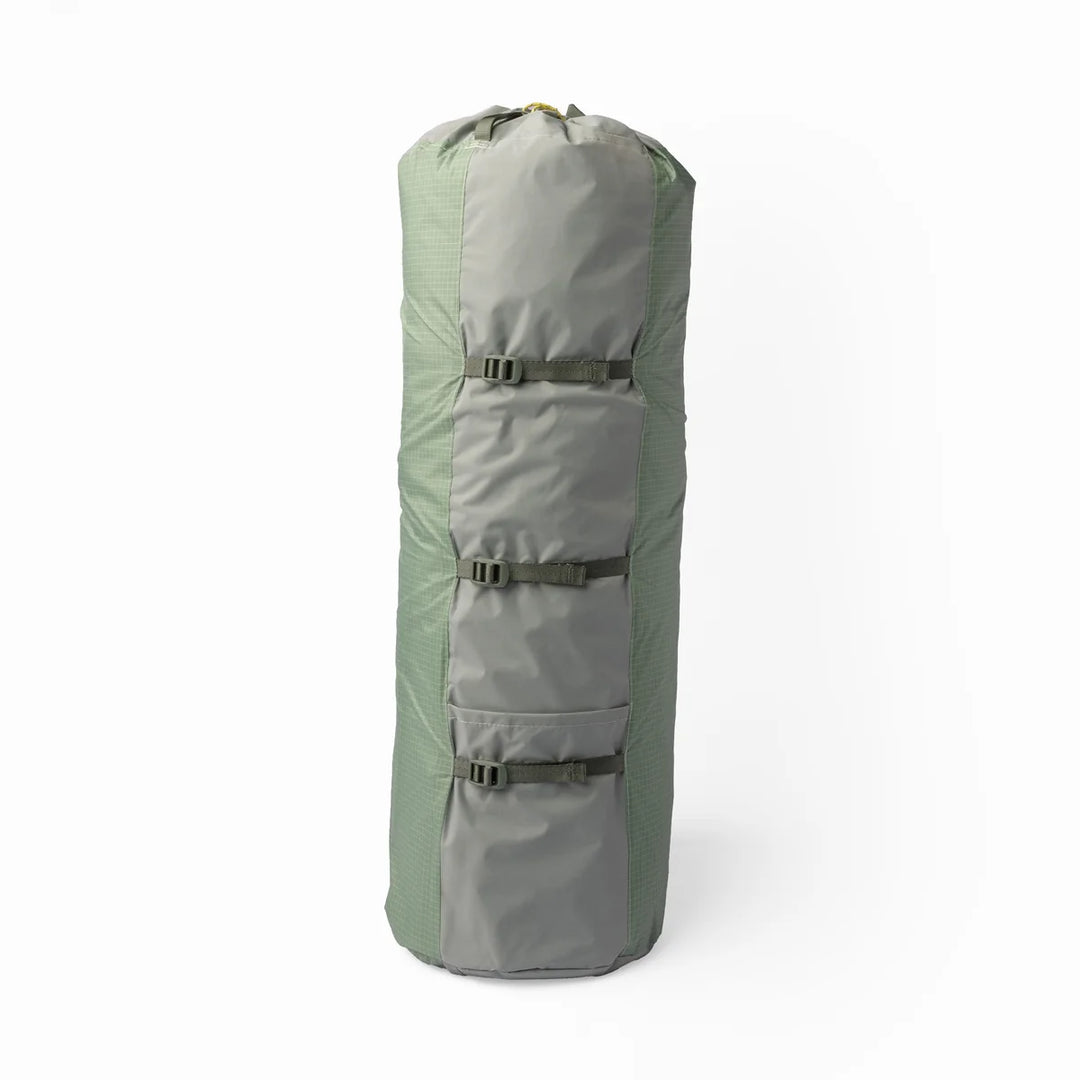 A light green packed up camping tent on a white background 