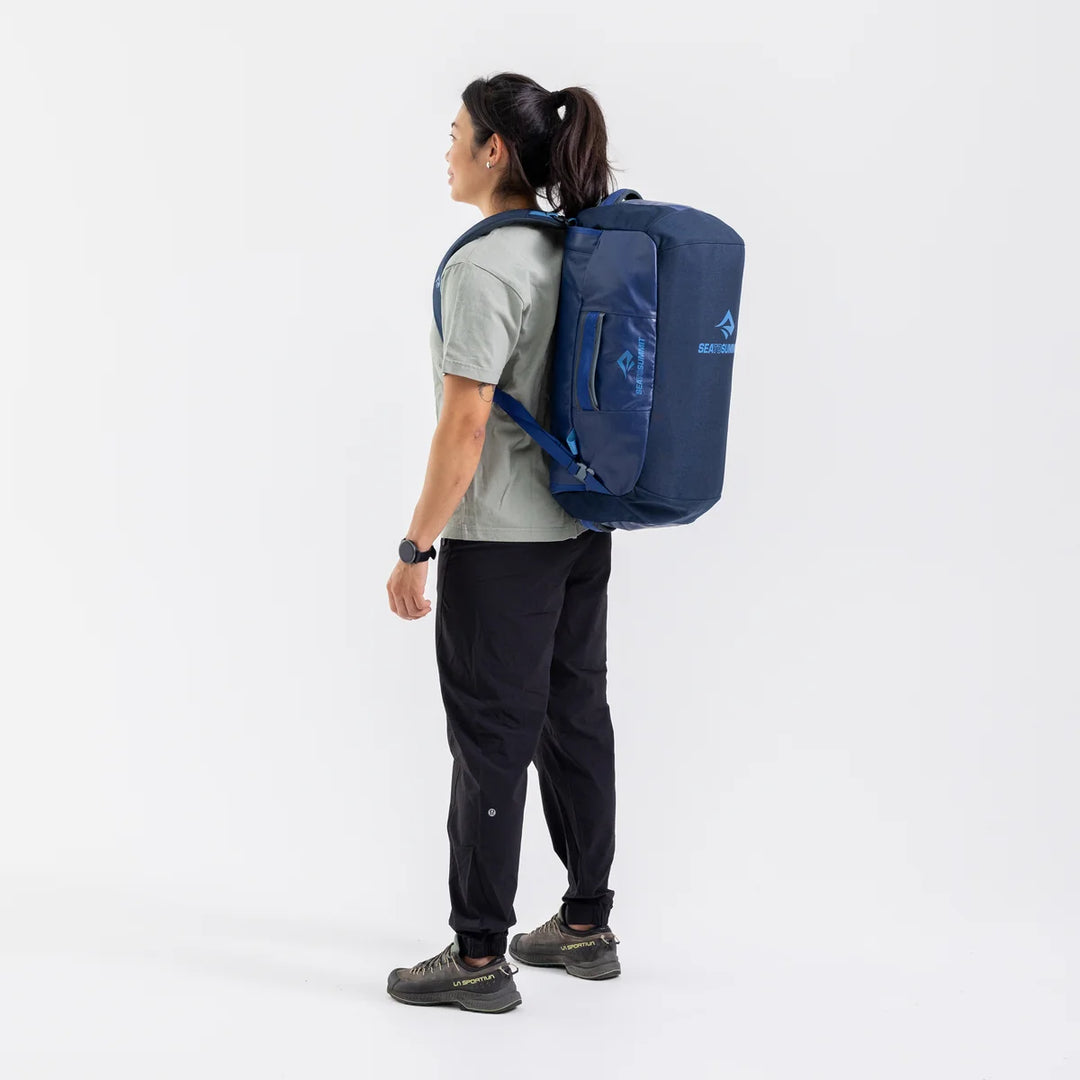 Person wearing a blue backpack on a white background
