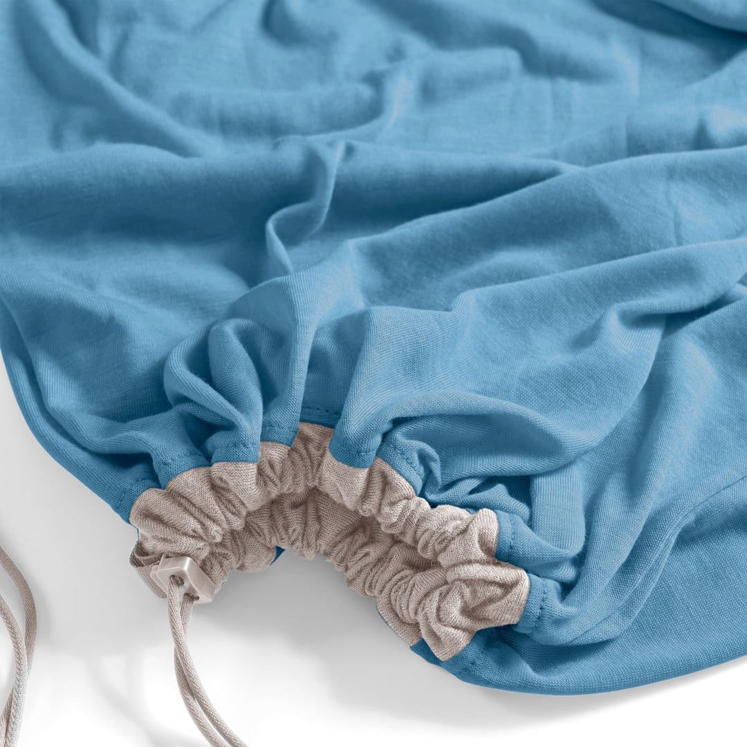 Blue sleeping bag liner with white drawstring on a white background