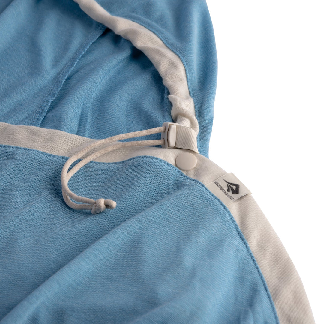Close-up of a blue and beige fabric with a drawstring and brand logo on a white background