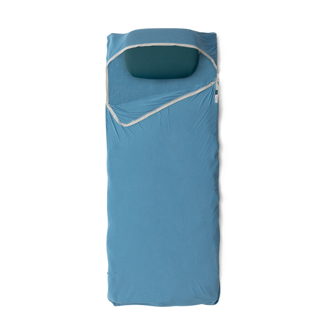 Blue sleeping bag liner with white trim on a white background