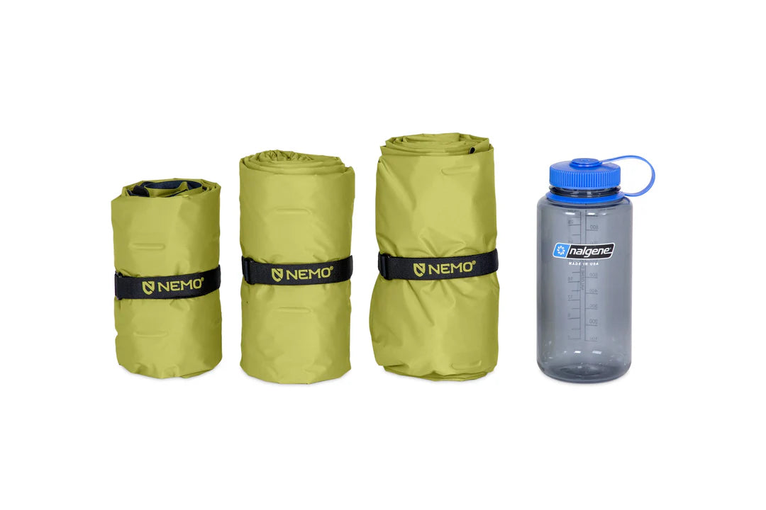 Three rolled-up sleeping mats with Nemo branding and a Nalgene water bottle on a white background.