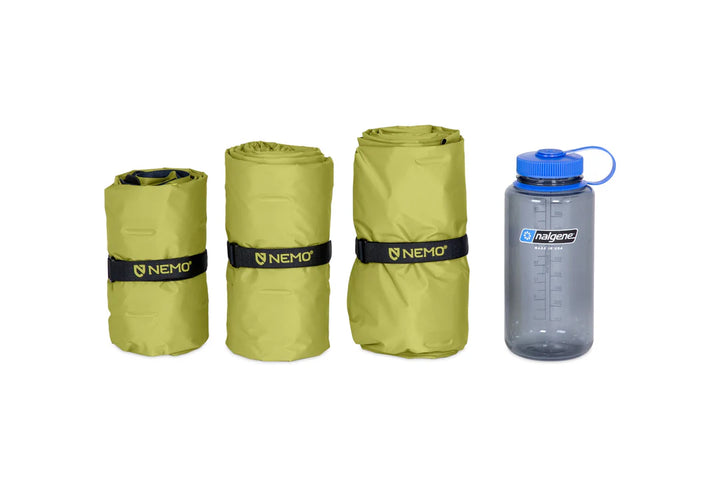 Three rolled-up sleeping mats with Nemo branding and a Nalgene water bottle on a white background.