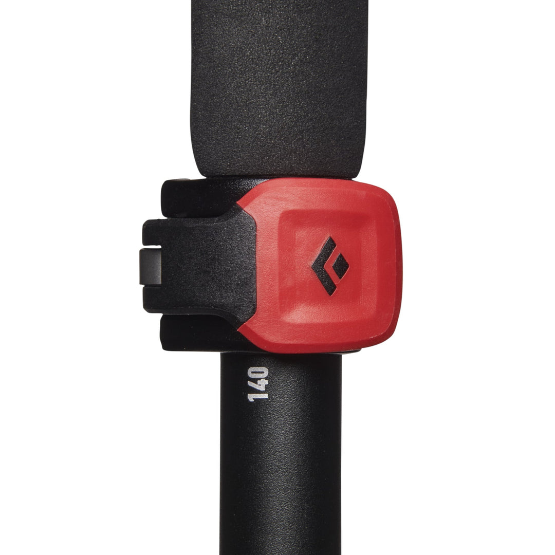 Red plastic lever for securing two sections of a collapsible trekking pole