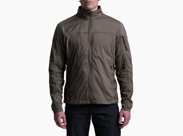 Man wearing a brown jacket and jeans on a white background