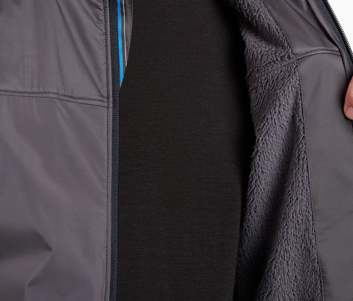 Close up of an unzipped dark gray jacket showing a fluffy lining