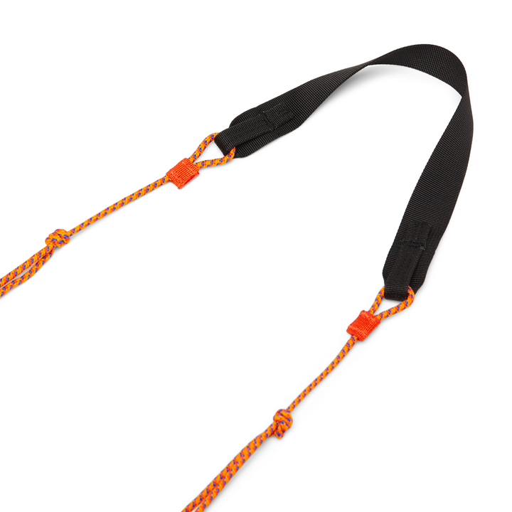Black strap with cord extensions of bright orange cord
