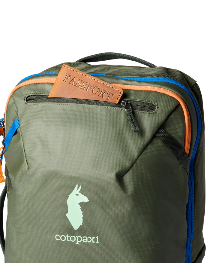 Green backpack with a passport sticking out of the top zip pocket