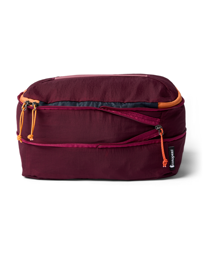 Maroon packing cube with orange zippers on a white background