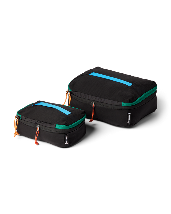 Two black packing cubes with teal and orange accents on a white background