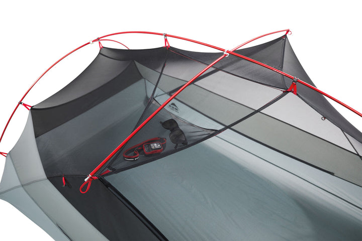 Grey camping tent with red poles on a white background