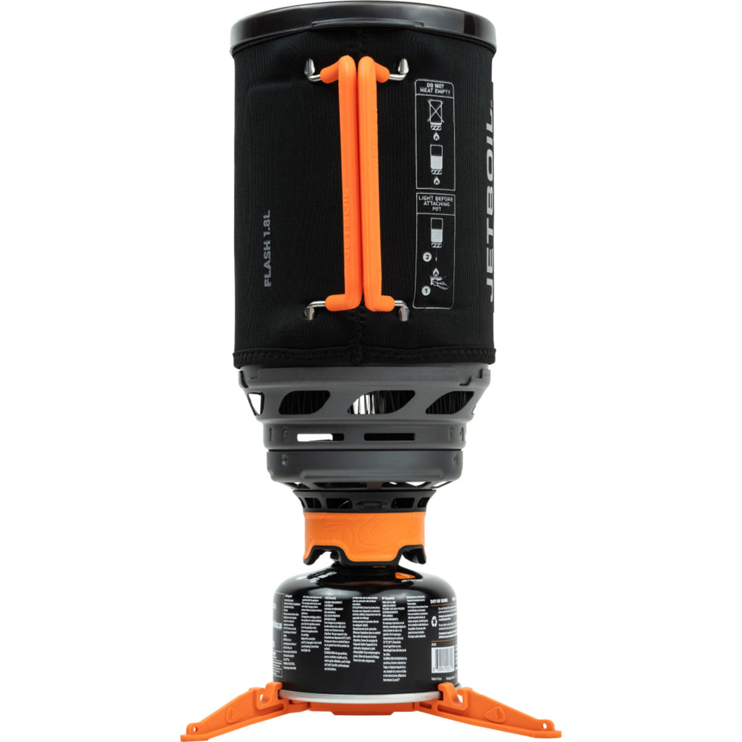 Black and orange camping stove with fuel canister on a white background