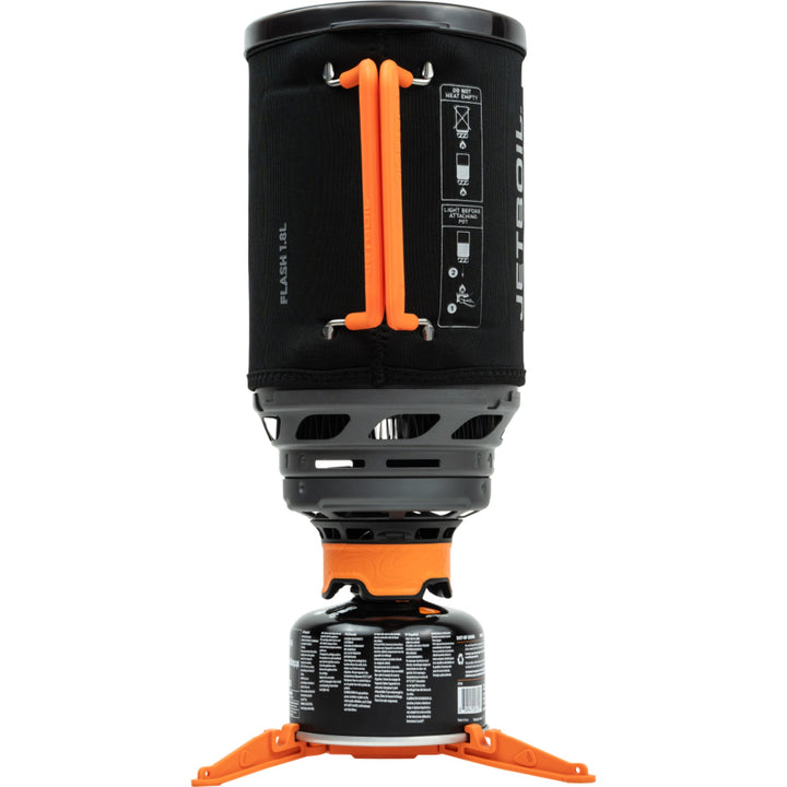 Black and orange camping stove with fuel canister on a white background