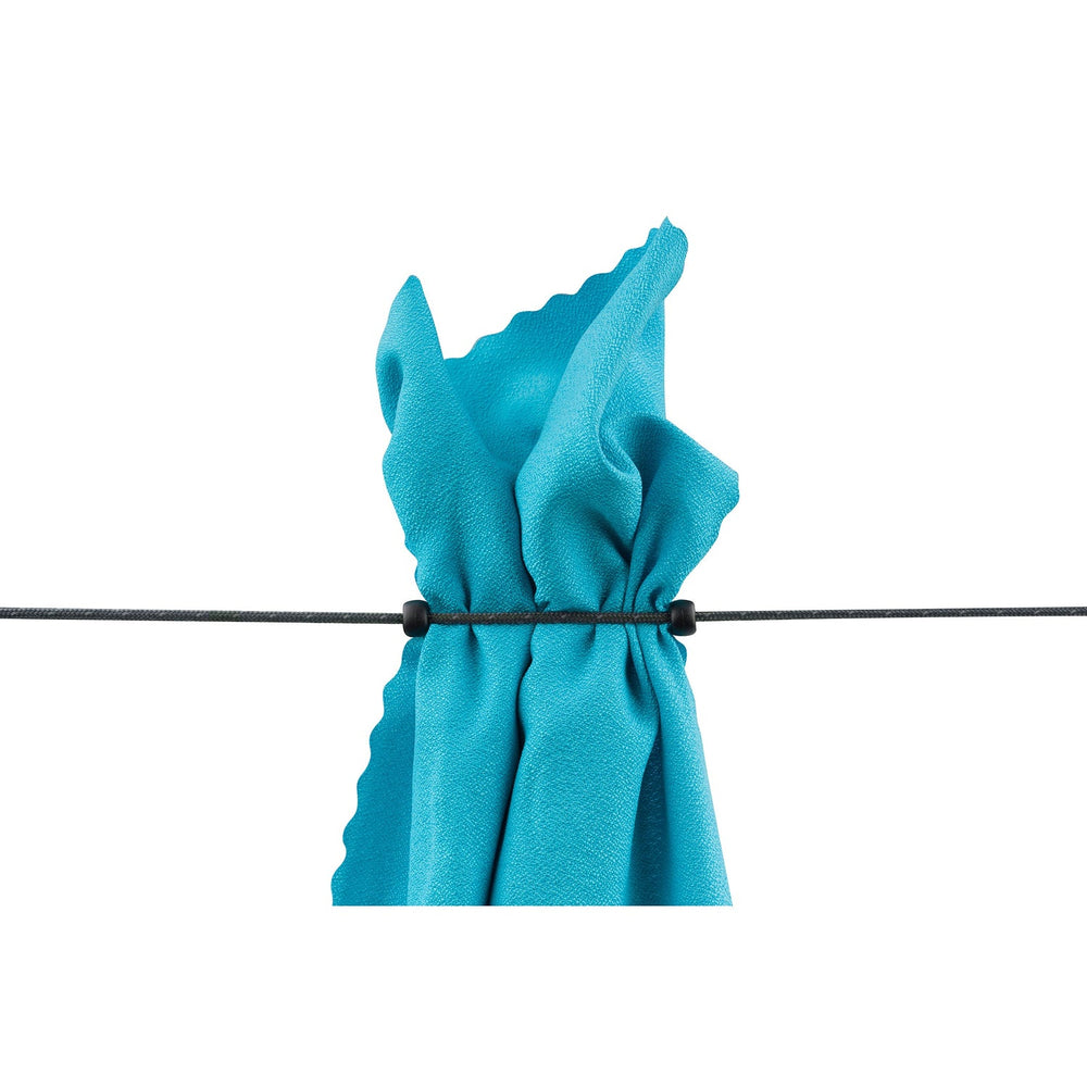 Travel towel hung from a clothes line between two rubber beads