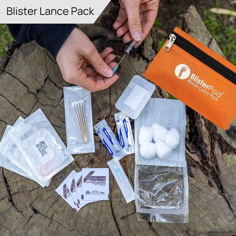 Blister treatment pack with various components spread out on a wooden surfaces