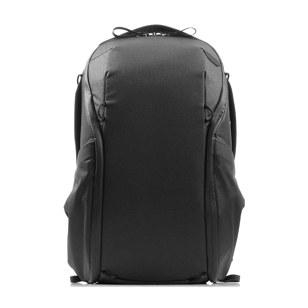 A black technical backpack shown from the back, featuring a structured design with multiple zippered compartments and padded shoulder straps, set against a plain white background.