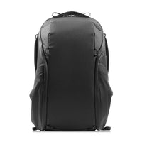 A black technical backpack shown from the back, featuring a structured design with multiple zippered compartments and padded shoulder straps, set against a plain white background.