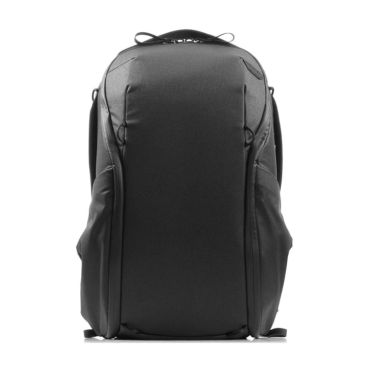 A black technical backpack shown from the back, featuring a structured design with multiple zippered compartments and padded shoulder straps, set against a plain white background.