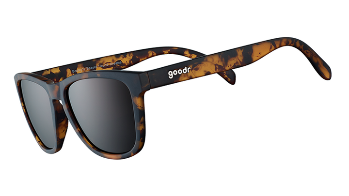 Sunglasses with tortoiseshell frame and dark lenses on a white background