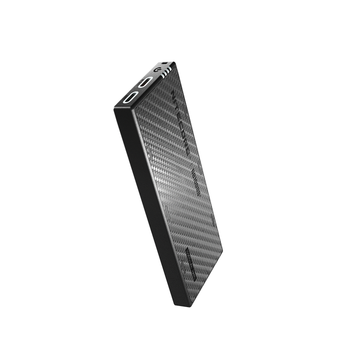 Black portable power bank with carbon fiber texture on a white background