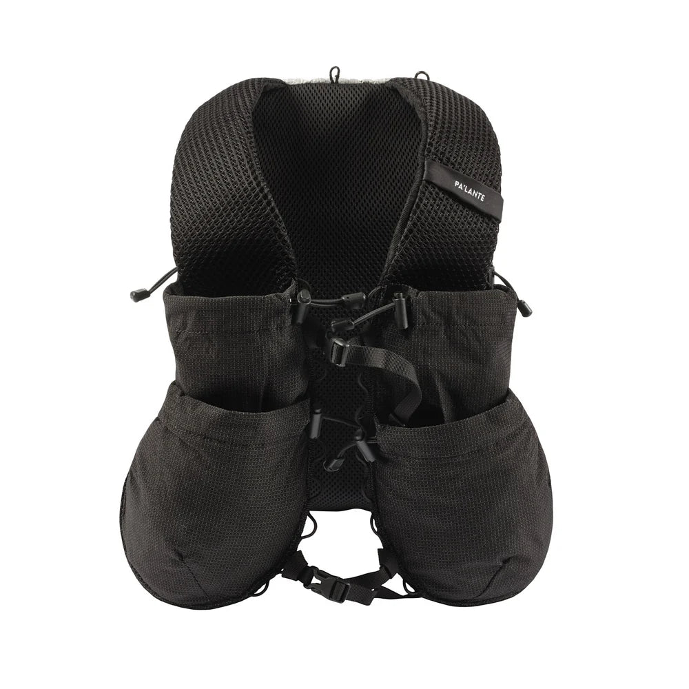 Black backpack style vest with multiple pockets and straps on a white background