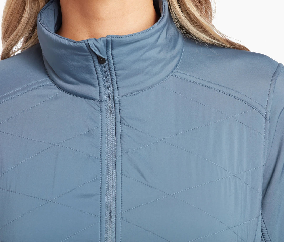 Close up of the upper torso of a light blue quilted jacket