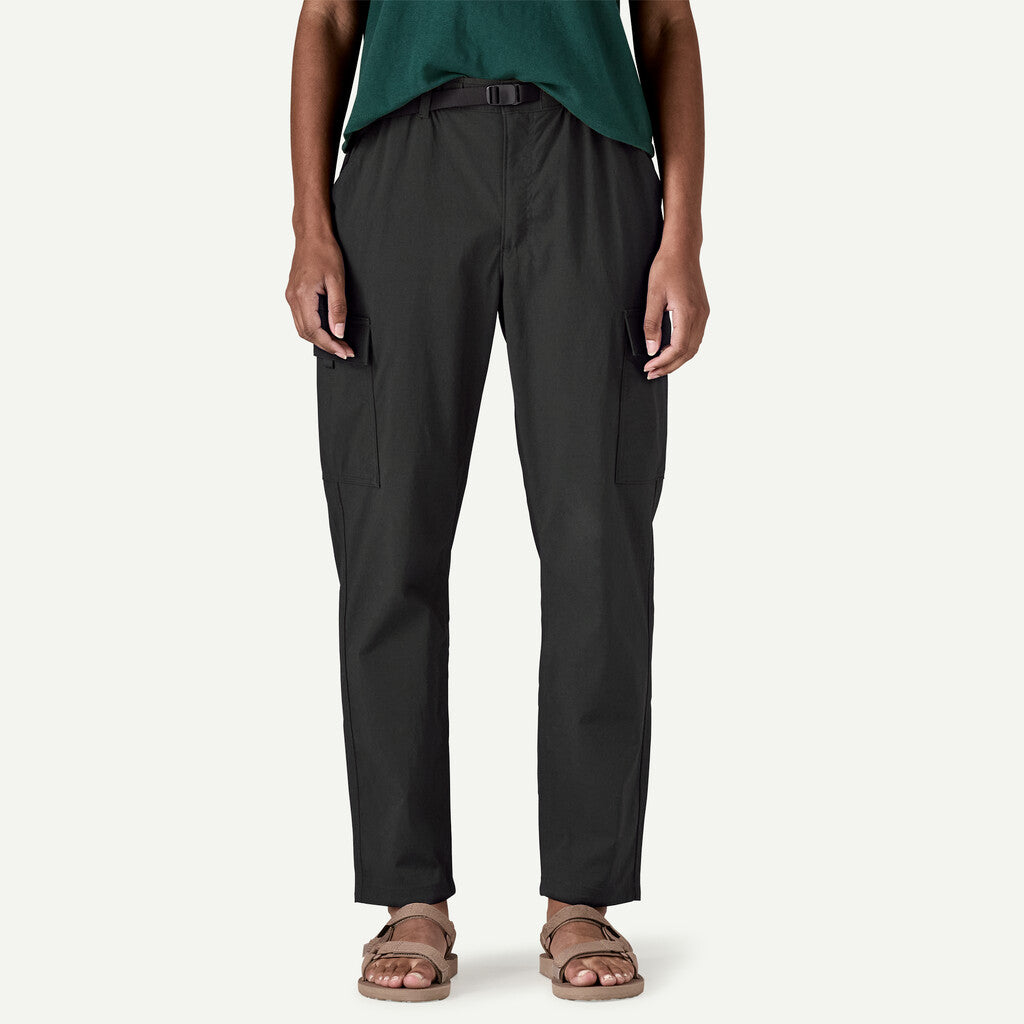 Person wearing black pants on a white background