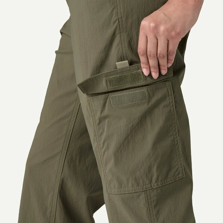 Close-up of olive green pants with a pocket on a white background