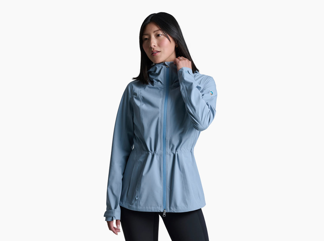 Woman wearing a pale blue raincoat on a white background