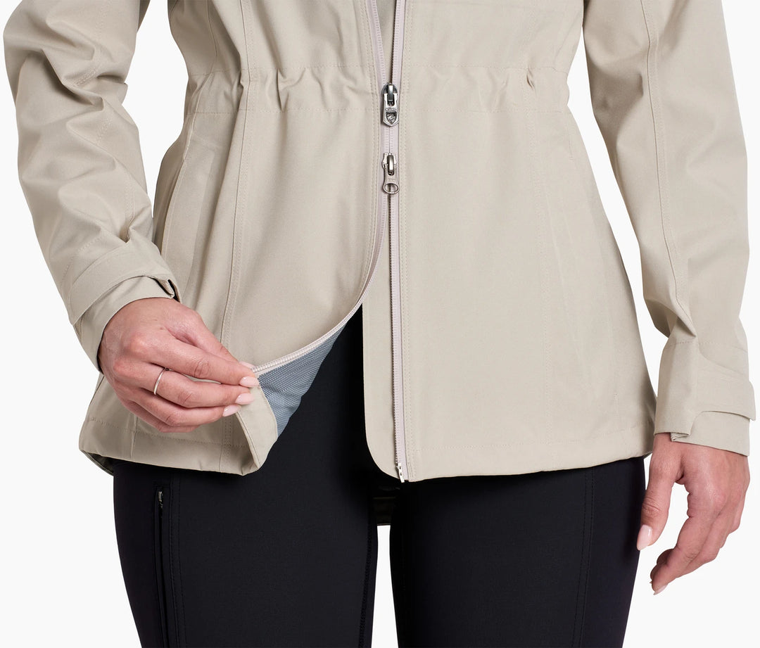 Lower torso of a woman wearing a rain coat showing a two way zipper